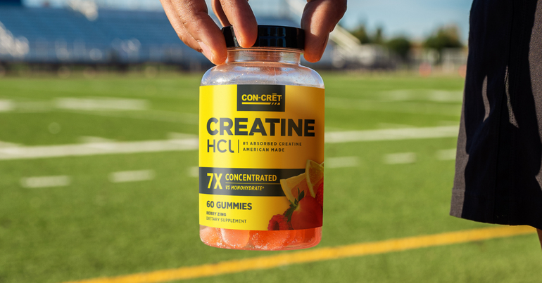 Creatine Gummies being held in a man's hand