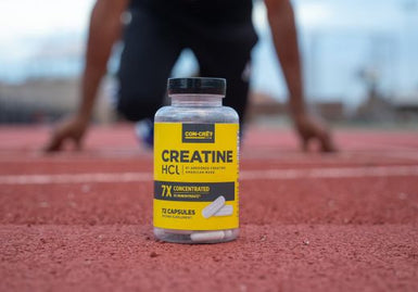 CON-CRET Creatine HCl capsules on a track with an athlete preparing to sprint, symbolizing NSF Certified for Sport quality.